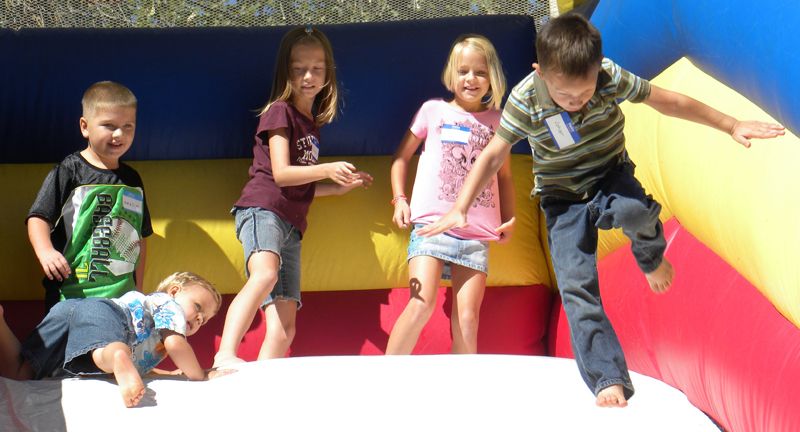 Kids playing on a bounce house