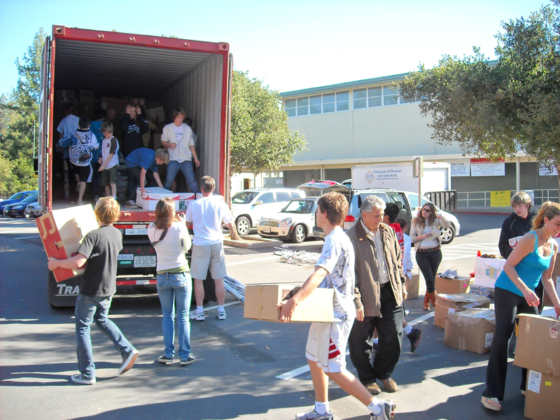 Volunteers load donated items into a truck