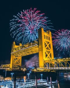 Sacramento Golden Bridge with fireworks behind it.