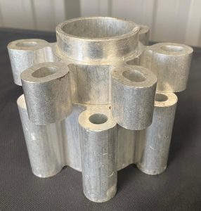 A silver, cylindrical part from a truck