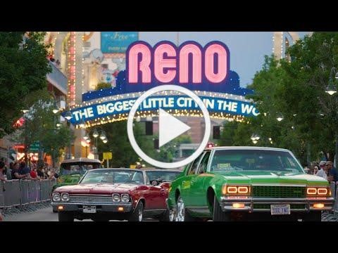 Picture of two 80 impala, Red on the left and Green on the right driving down Downtown Reno.