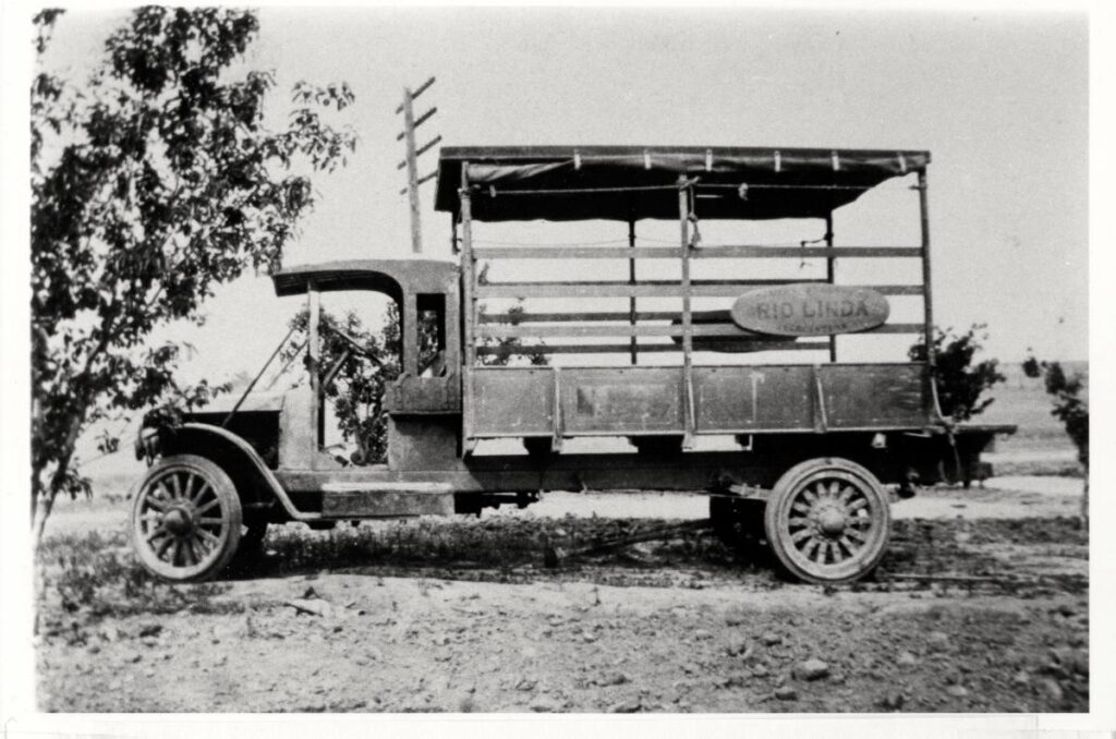 Black and white photo of an old devine truck.