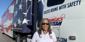 Dee Sova posing for a picture in front of a america themed truck.