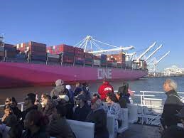 View of the side of ONE container ship docked.