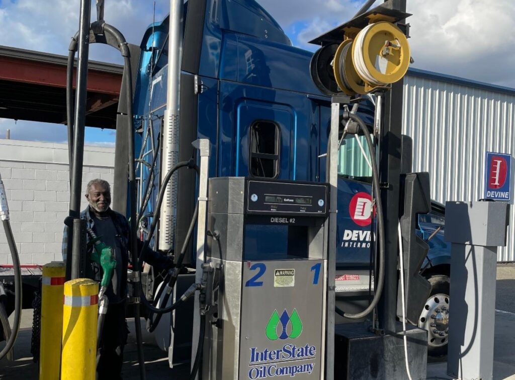 Devine employee driver filling up fuel for his truck.
